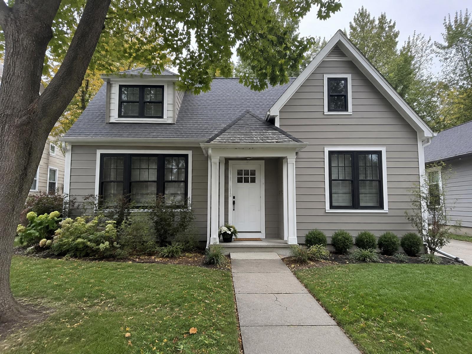 Example of a Kansas City bungalow with taupe lap siding and white trim